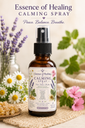Bottle of 'Essence of Healing' calming spray with flowers and herbs in the background.  All Natural ingredients. Made with pure essential oils. 